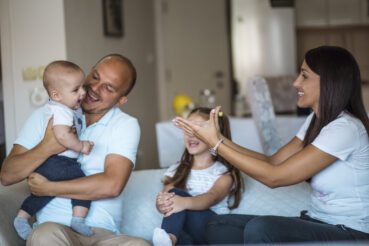 Happy young family on couch