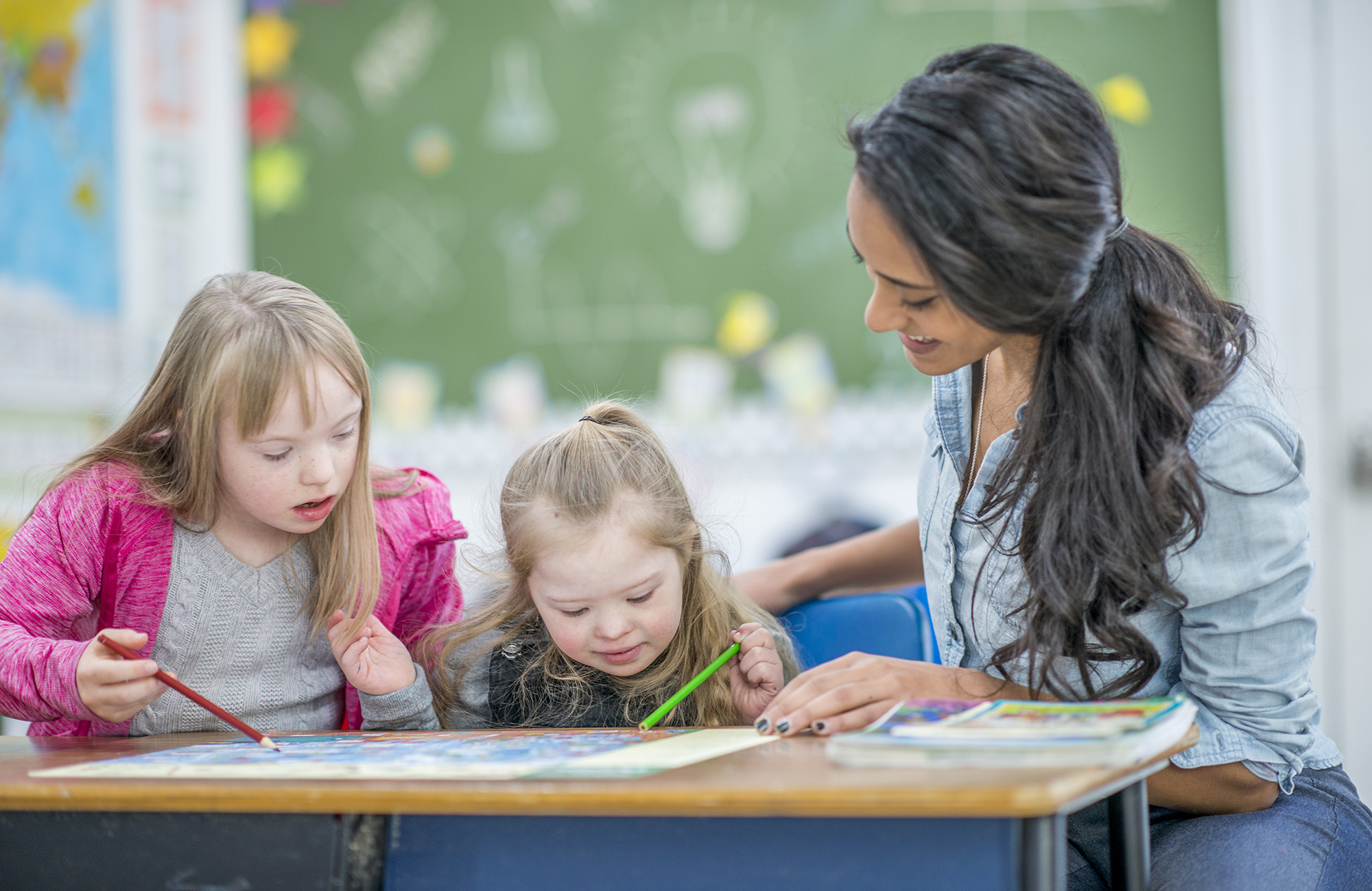 Two children with teacher at school