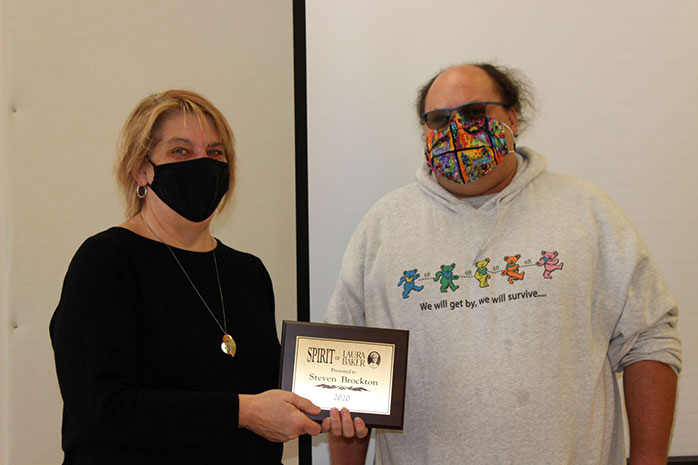 An Image of Steve Brockton receiving the Spirit of Laura Baker Award from Sandi Gerdes