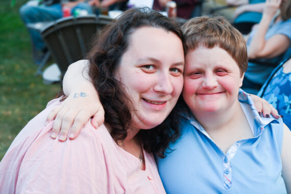 two friends sitting outside together