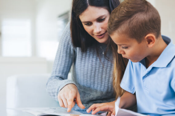 young boy getting tutored in reading